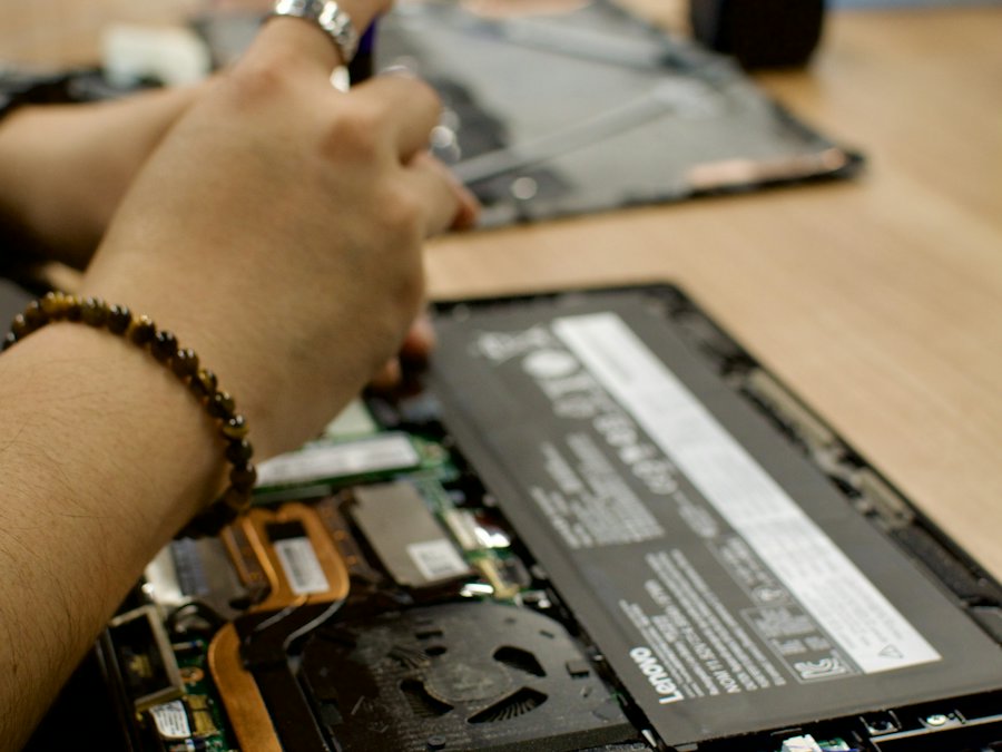 Technician repairing an opened laptop
